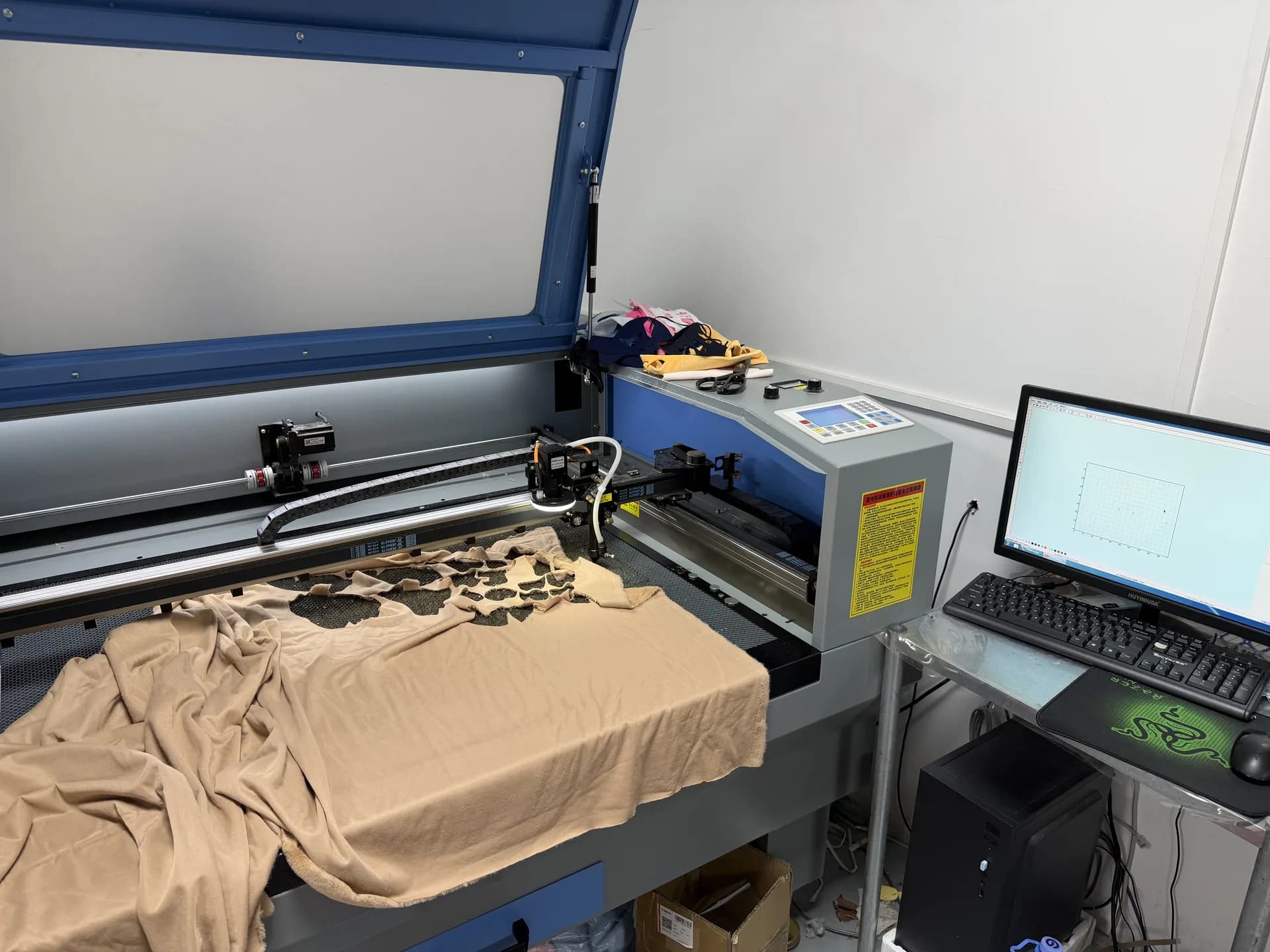 Automated fabric cutting equipment preparing plush pattern pieces in our Shenzhen workshop